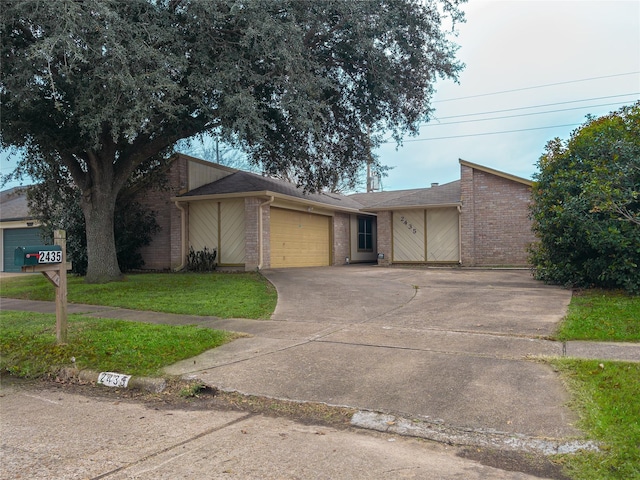 view of front of house featuring a garage and a front lawn