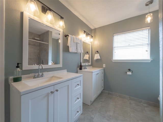 bathroom with tile patterned flooring, vanity, and walk in shower