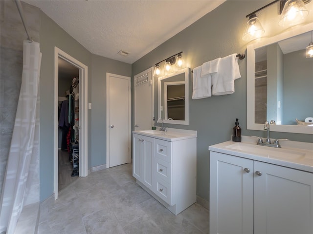 bathroom featuring vanity and a textured ceiling