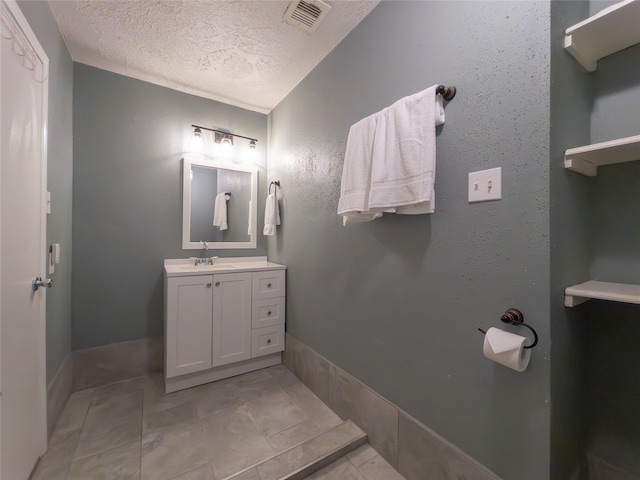 bathroom featuring vanity and a textured ceiling