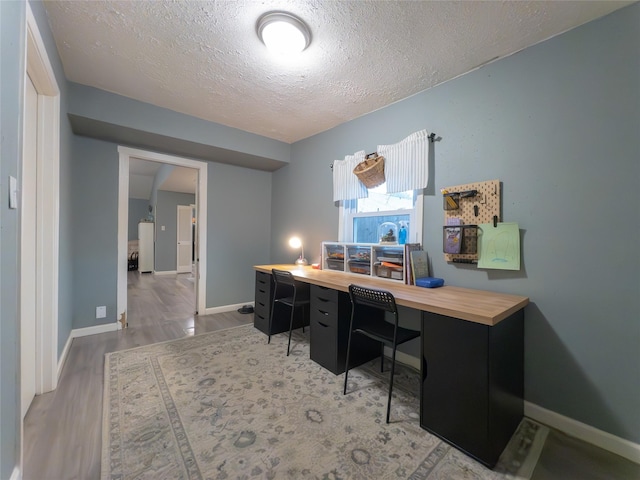 office featuring wood-type flooring and a textured ceiling