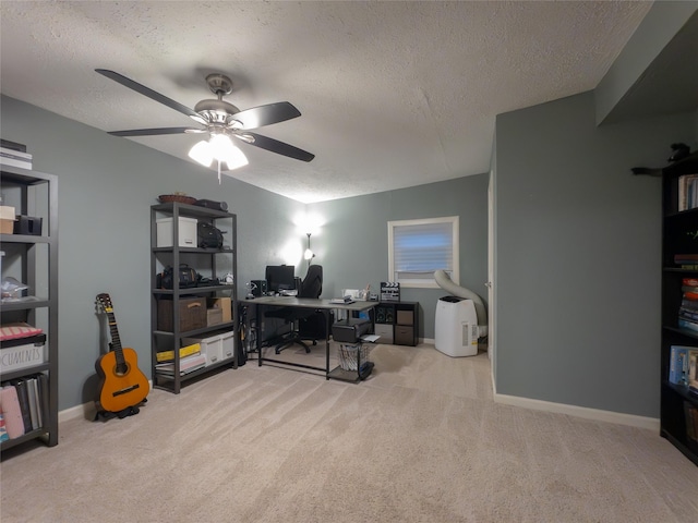 carpeted office with ceiling fan and a textured ceiling