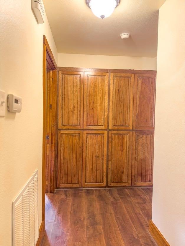 corridor featuring dark hardwood / wood-style flooring