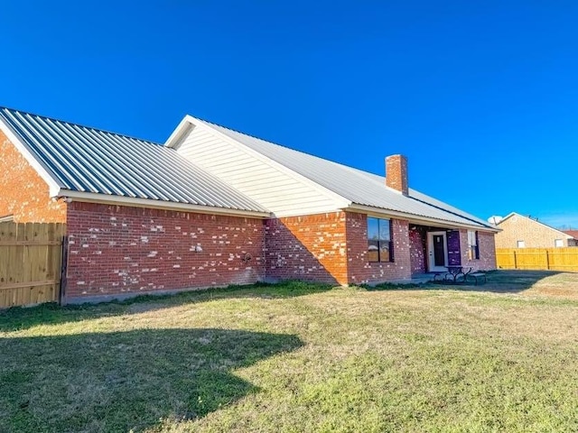 rear view of house with a yard