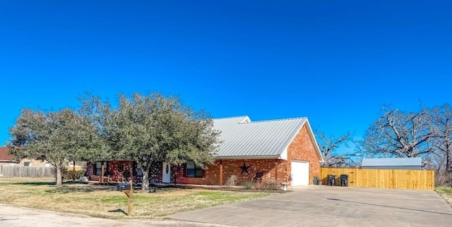 view of front of home with a garage and a front yard