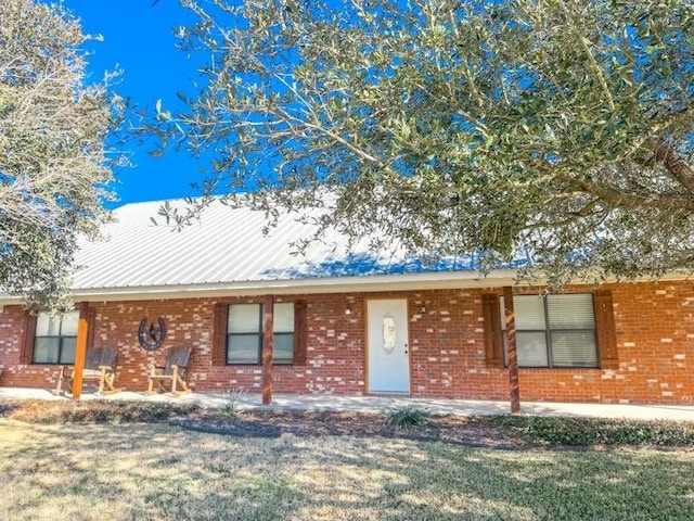 ranch-style house with a front lawn and a patio