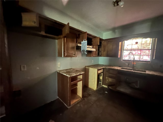 kitchen with sink and light stone countertops