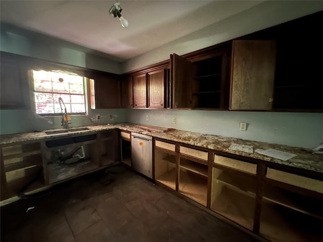 kitchen featuring dishwasher, light stone countertops, and sink