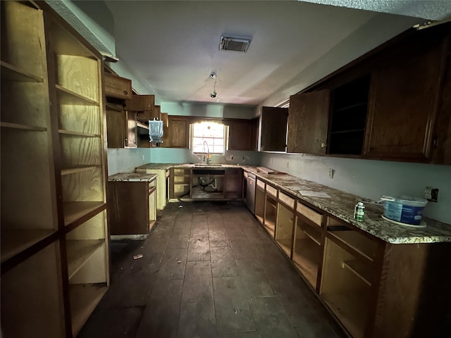 kitchen with dark wood-type flooring, stainless steel dishwasher, sink, and light stone counters