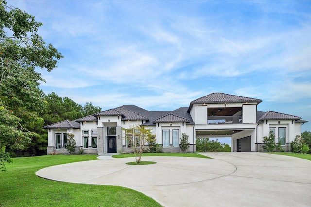 mediterranean / spanish-style house featuring a garage, a front yard, and french doors