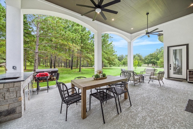 view of patio with ceiling fan, sink, and area for grilling