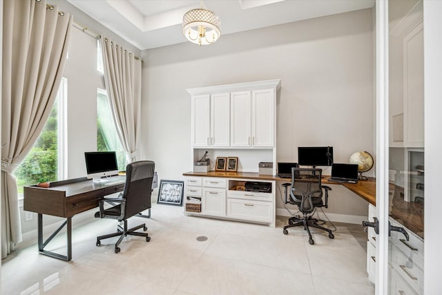 office with light tile patterned floors and a high ceiling