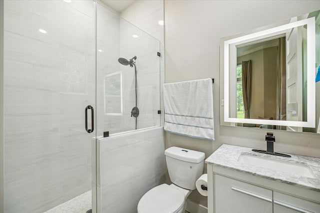 bathroom with vanity, an enclosed shower, and toilet