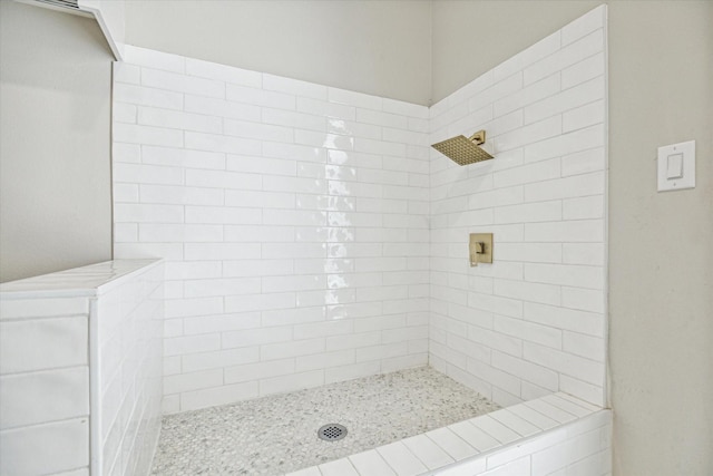 bathroom with a tile shower