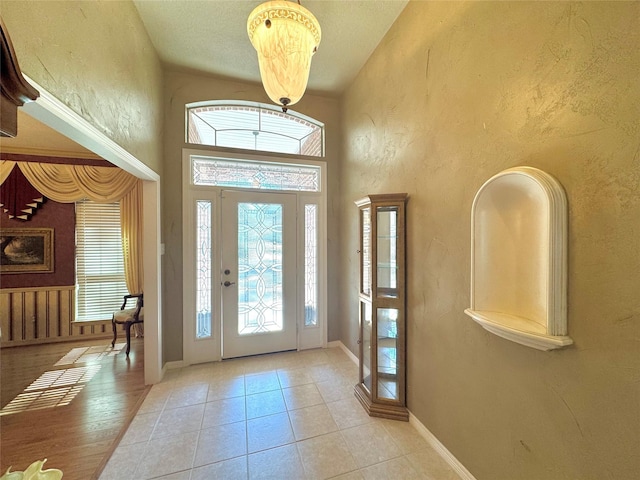 tiled foyer with a high ceiling