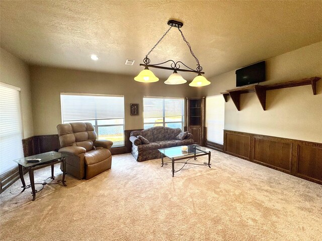 living room featuring light carpet and a textured ceiling