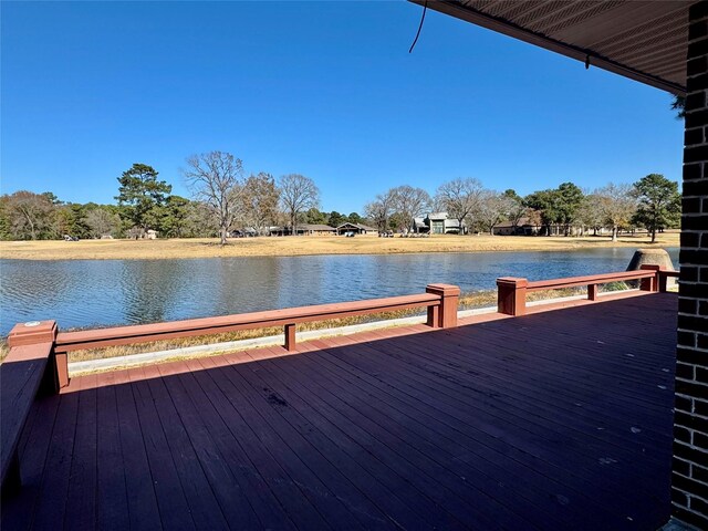 dock area featuring a deck with water view