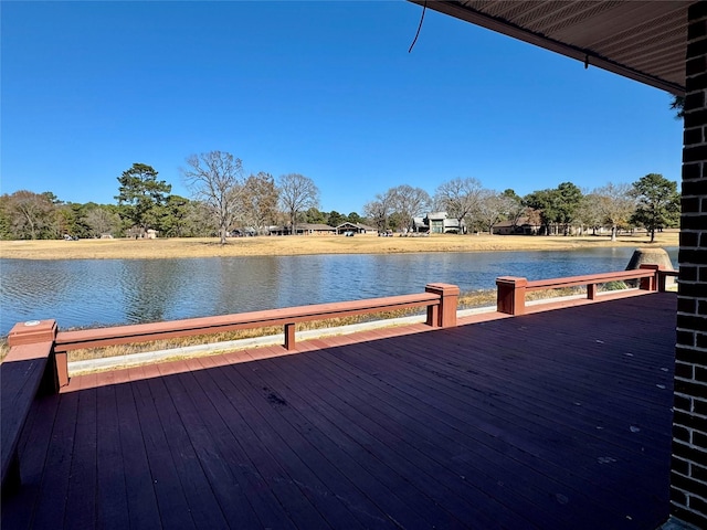 view of dock with a deck with water view