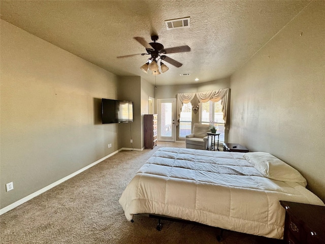 bedroom with carpet floors, access to exterior, visible vents, a textured ceiling, and baseboards