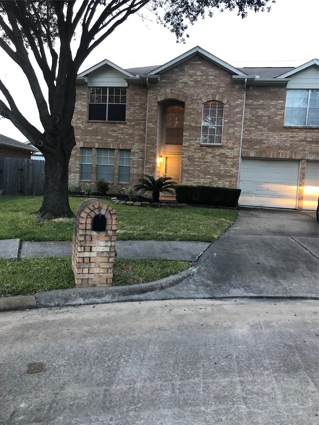 view of front facade with a garage and a front lawn