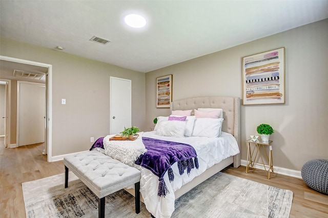 bedroom with hardwood / wood-style flooring