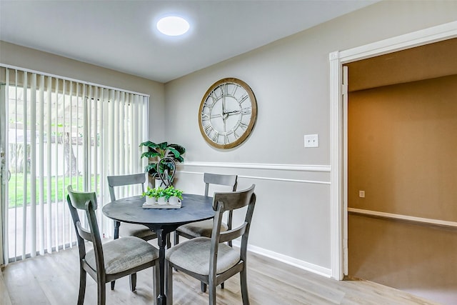 dining space with light hardwood / wood-style floors