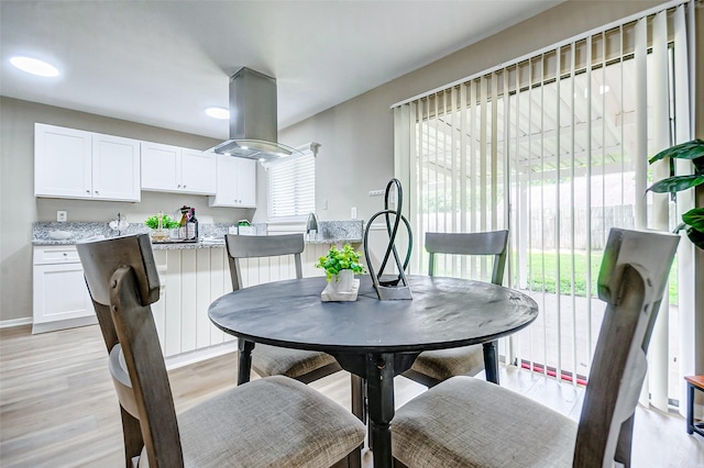 dining area with light hardwood / wood-style flooring