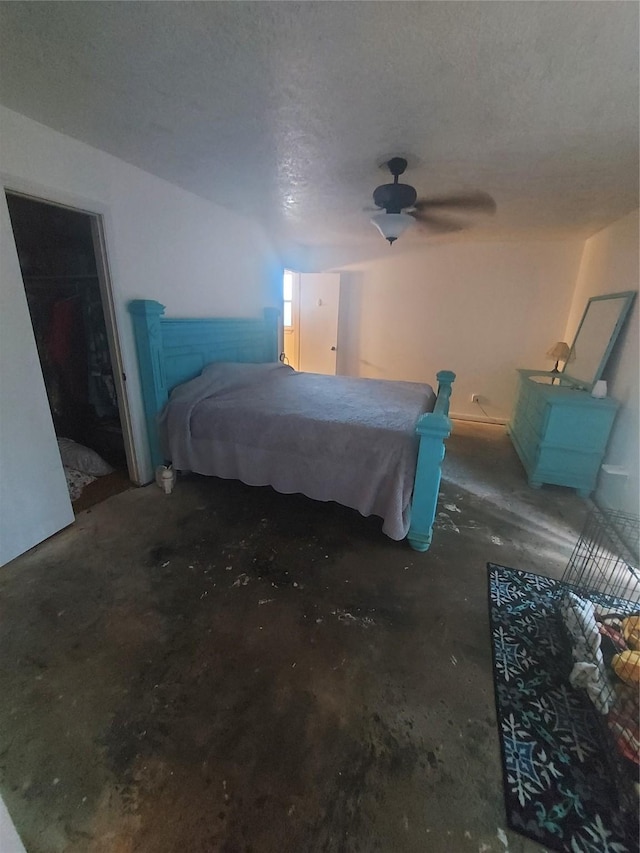 bedroom with ceiling fan and a textured ceiling