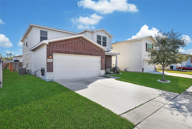 traditional-style home with brick siding, concrete driveway, central AC unit, a front yard, and fence