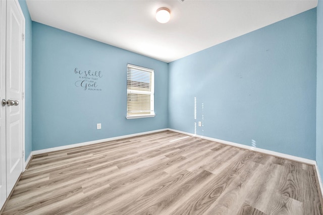 unfurnished room featuring light wood-type flooring and baseboards