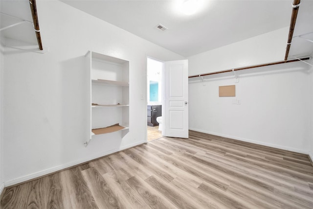 spacious closet featuring visible vents and light wood-style floors