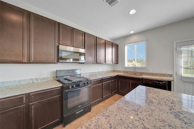 kitchen featuring dark brown cabinetry, black appliances, visible vents, and a sink