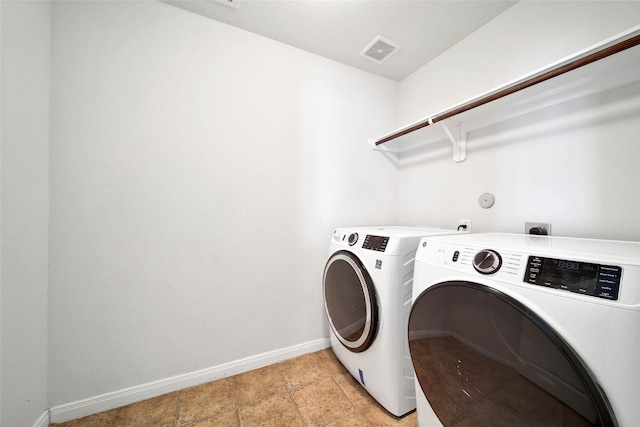 clothes washing area featuring separate washer and dryer