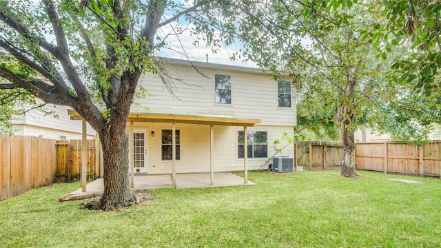 back of property featuring cooling unit, a yard, and a patio