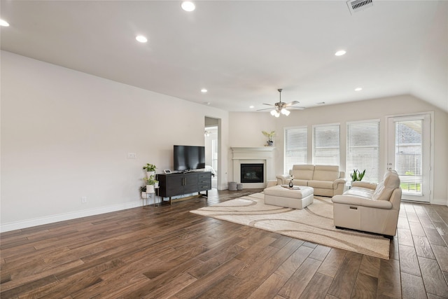 living room featuring dark wood-type flooring and ceiling fan