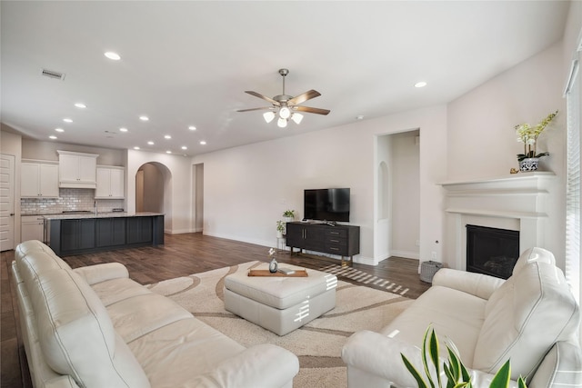 living room featuring hardwood / wood-style flooring and ceiling fan