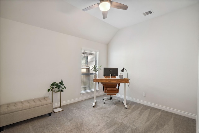 carpeted home office with ceiling fan and vaulted ceiling