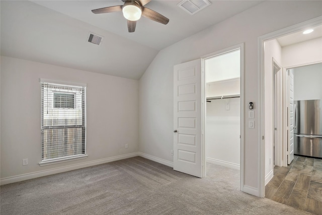 additional living space with light carpet, vaulted ceiling, and ceiling fan