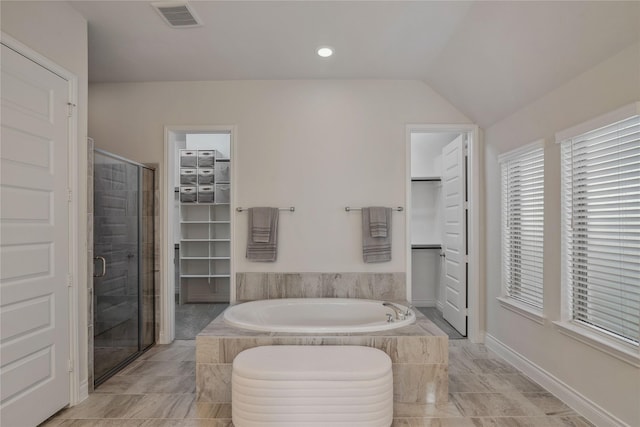 bathroom featuring plus walk in shower and vaulted ceiling