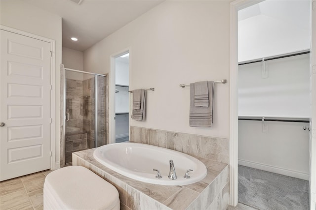 bathroom featuring separate shower and tub