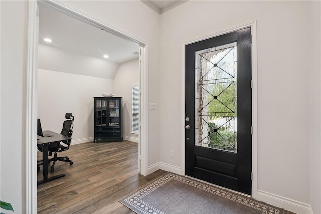 foyer with lofted ceiling and dark wood-type flooring