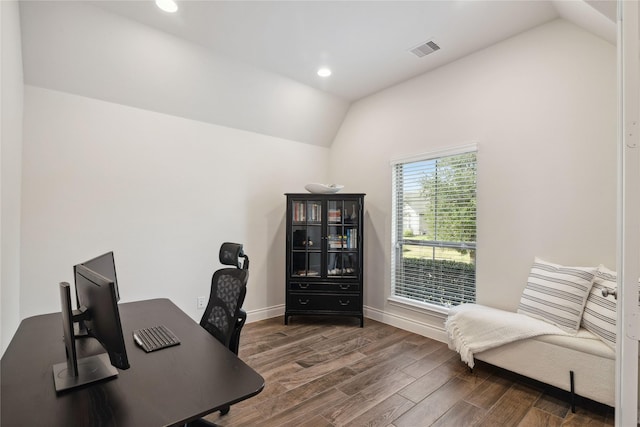 home office with lofted ceiling and dark hardwood / wood-style floors