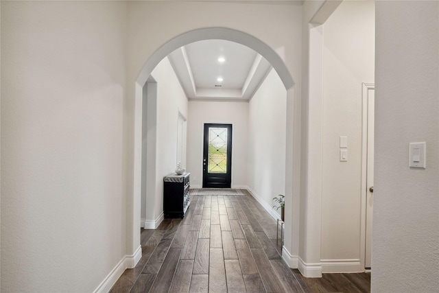 doorway to outside featuring a tray ceiling