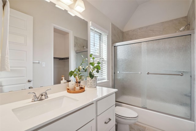 full bathroom with toilet, vanity, shower / bath combination with glass door, and vaulted ceiling