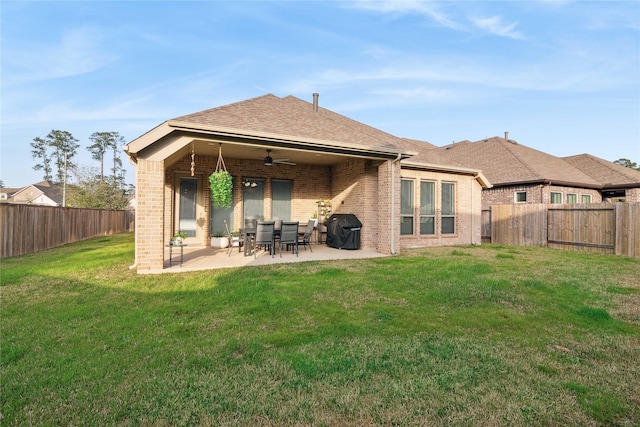 rear view of property featuring a patio, a yard, and ceiling fan