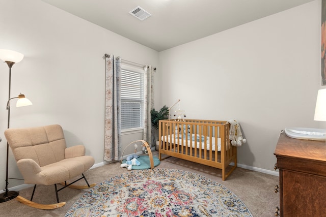 carpeted bedroom featuring a crib