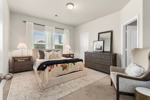 bedroom featuring light colored carpet