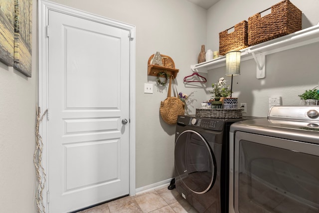 washroom featuring light tile patterned floors and washing machine and clothes dryer