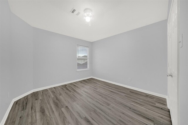 spare room featuring hardwood / wood-style flooring and ceiling fan