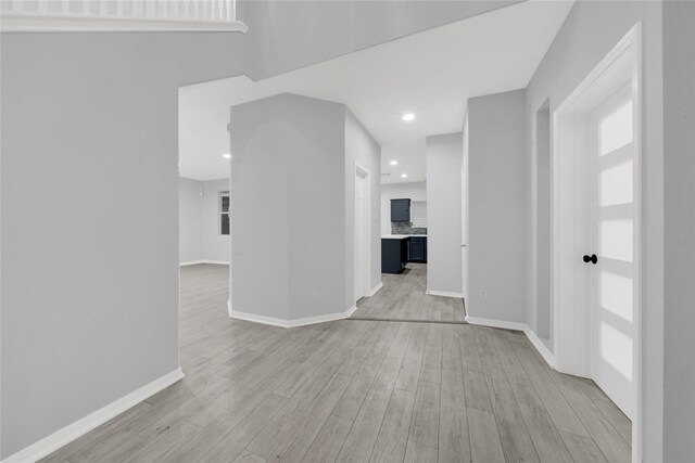 unfurnished room with light wood-type flooring